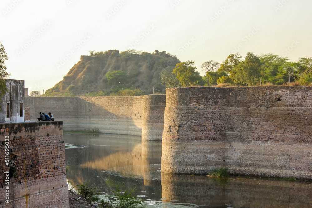 Fototapeta premium The ancient Lohagarh fort with the bridge across the river moat in the town of Bharatpur.
