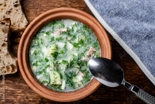 Okroshka, Russian cold soup on a wooden background.