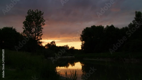 sunset over a river time lapse wonderful red orange sundown in the evening. colorful dawn. 