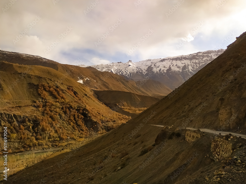 road to the mountains with snow covered top mountains road to the mountains with snow covered top mountains