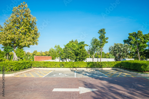 Wallpaper Mural Empty space handicapped parking sign in city park outdoor concrete parking lot area with blue sky. Green nature gardening in car parking lot. Friendly environmental and transportation concept. Torontodigital.ca