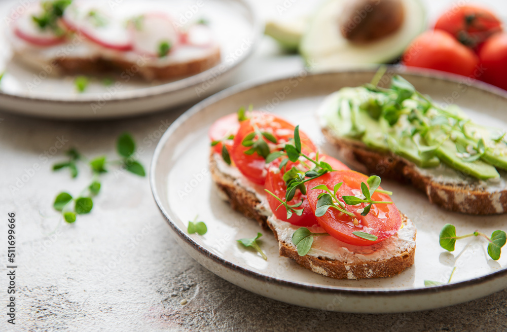 Different sandwiches with vegetables and microgreens Different sandwiches with vegetables and microgreens