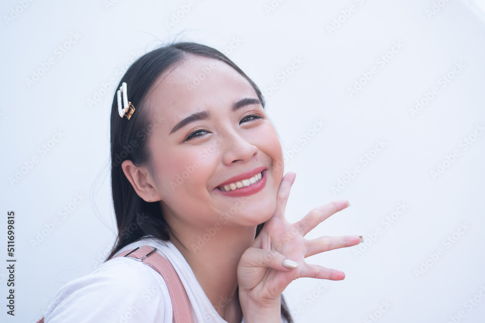Confident asian woman pointing up four fingers hand sign Confident asian woman pointing up four fingers hand sign