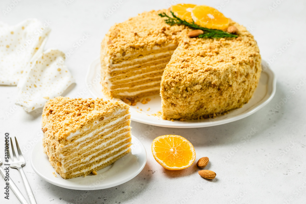 Almond honey cake sour cream frosting on plate. Space for text. Almond honey cake sour cream frosting on plate. Space for text.