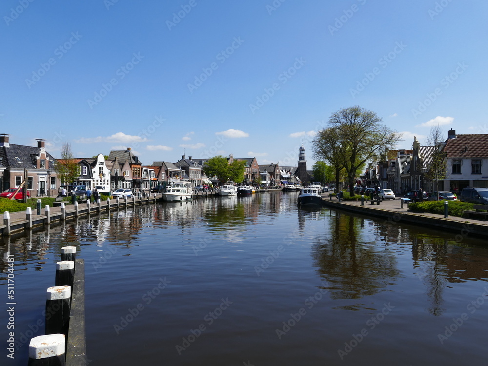 The wide canal running through (Dutch) Lemmer (Frisian) De Lemmer, Friesland, Netherlands, is popular with leisure boaters and tourists alike, with numerous restaurants and shops on both sides