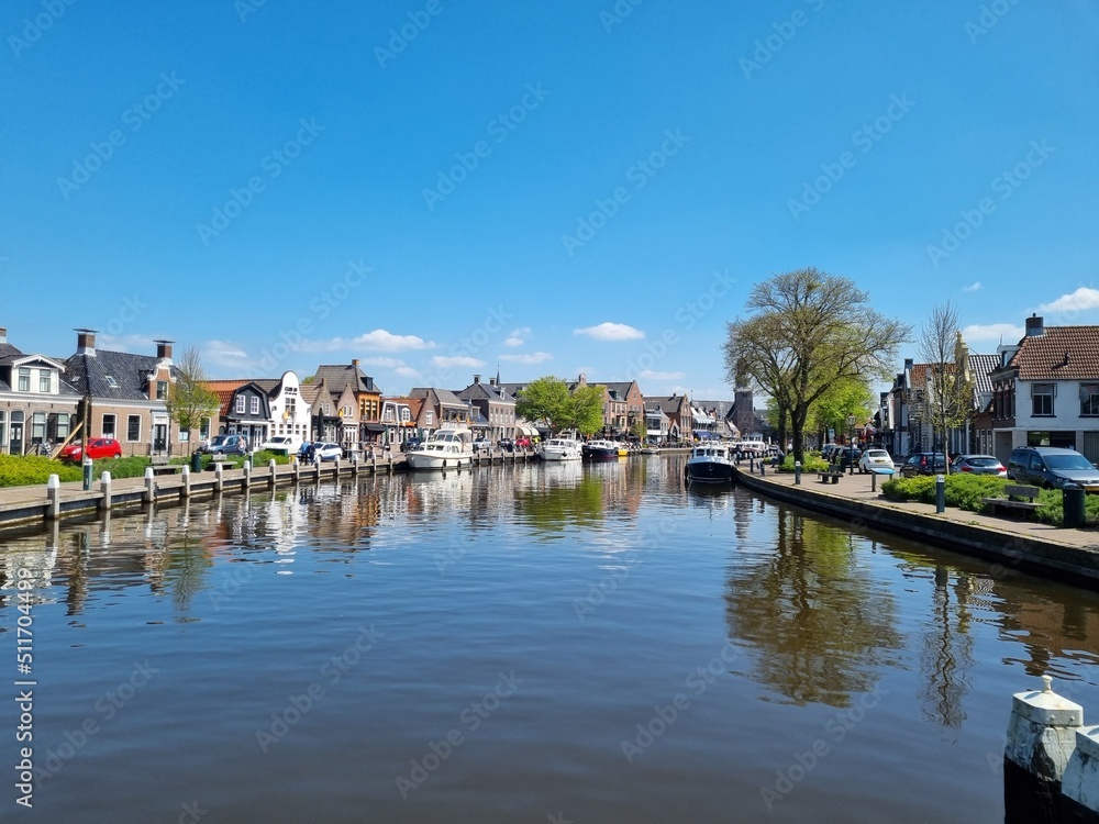 The wide canal running through (Dutch) Lemmer (Frisian) De Lemmer, Friesland, Netherlands, is popular with leisure boaters and tourists alike, with numerous restaurants and shops on both sides