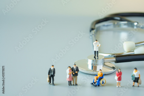 selective focus of miniature doctor on black stethoscope and miniature people with mask on white ground to solution for Annual Health Check up.
