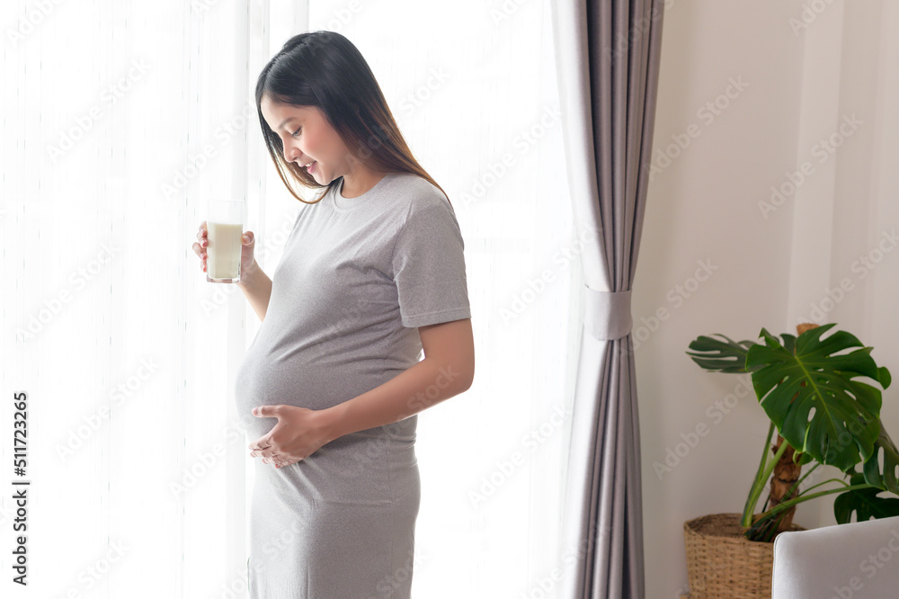 Young pregnant woman drinking milk at home, healthcare and pregnancy care Young pregnant woman drinking milk at home, healthcare and pregnancy care