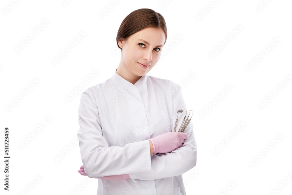 Portrait of happy young smiling girl dental doctor. Dressed in a black robe. Evenly standing with crossed hands holding medical instruments on a white background Portrait of happy young smiling girl dental doctor. Dressed in a black robe. Evenly standing with crossed hands holding medical instruments on a white background