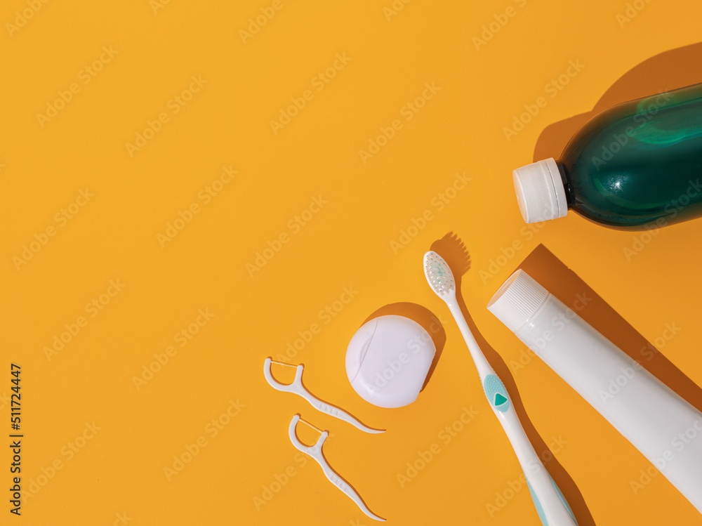 Accessories for the care of teeth and mouth on a yellow background. Place for text. View from above
