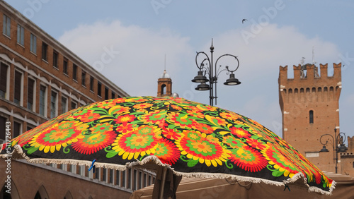 Wallpaper Mural Flea market. The umbrella of a stall and the Torre della Vittoria in the background, as if to say that summer has arrived in the city. Torontodigital.ca