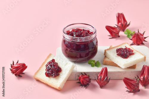 roselle jam and bread on pink background photo