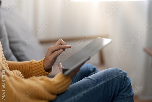 Woman pointing on digital tablet screen, chatting in social networks, meeting website, searching internet, sending sms, using text messenger or online banking. Close up photo.