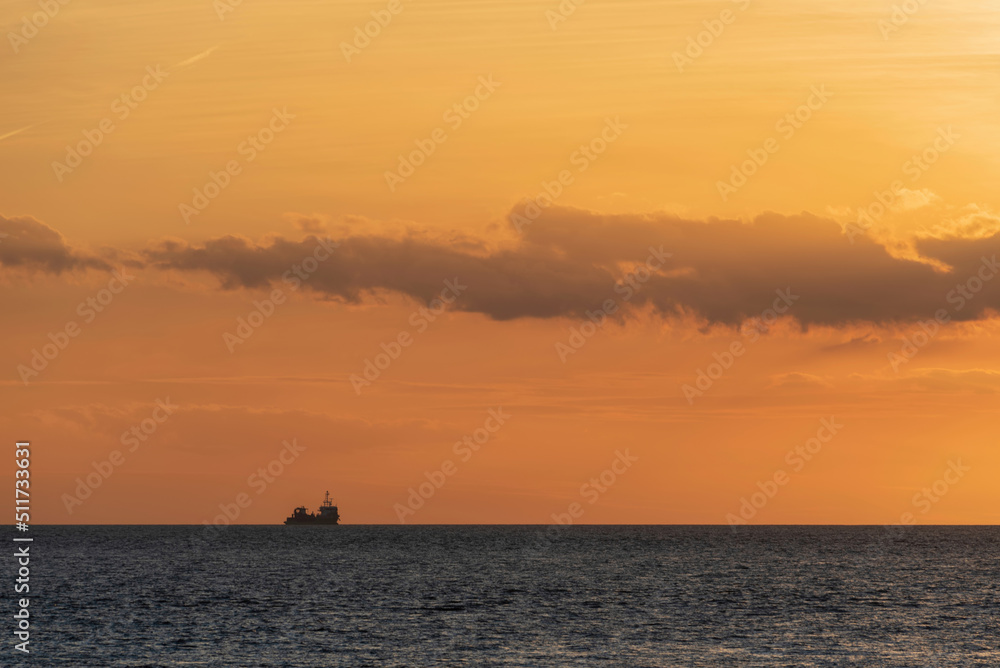 Beautiful colorful dramatic deep vibrant sunset over ocean landscape image