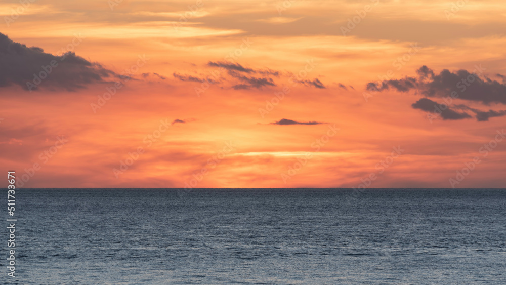 Beautiful colorful dramatic deep vibrant sunset over ocean landscape image