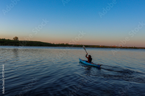 kayaking is a sport. guy in kayak on the water. summer evening. hobby sports. active life    © Наталья Удалова