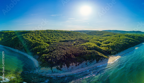 Panorama on village with hotels and inns on cliff with vegetation above the Black Sea against a clear sky