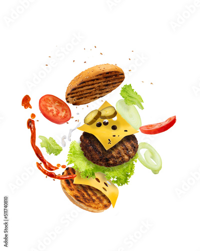 Big tasty hamburger with flying elements isolated on white background. Flying burger. Green background. Double cheeseburger