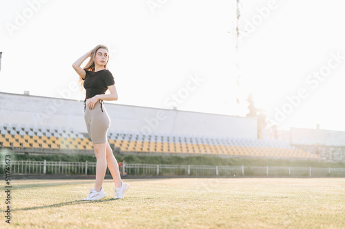 Full Length Slender Girl at the Stadium Sunset Summer Evening