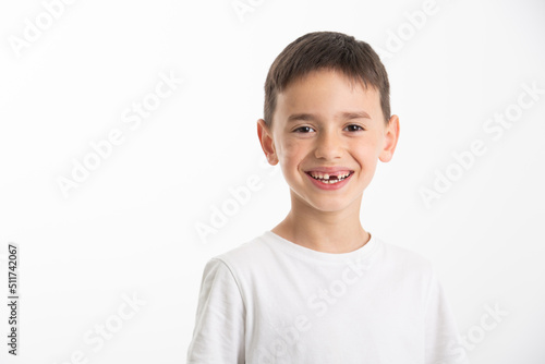a child smiles showing that a tooth has fallen out