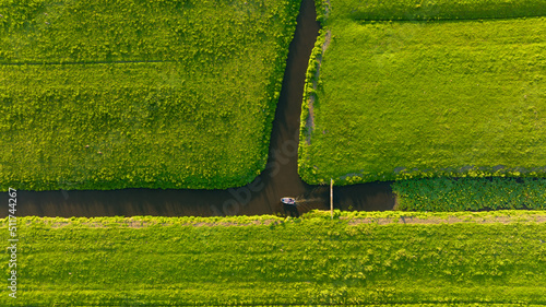 Aerial view of a canal boat in the Netherlands. Canals with water for agricul...