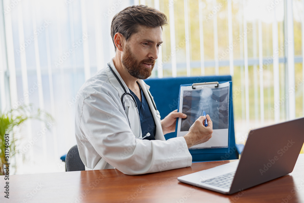 Therapist conducts video consultations, communicates with the patient through call by laptop Therapist conducts video consultations, communicates with the patient through call by laptop
