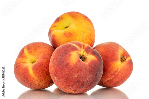 Four sweet organic peaches, close-up, isolated on white background.