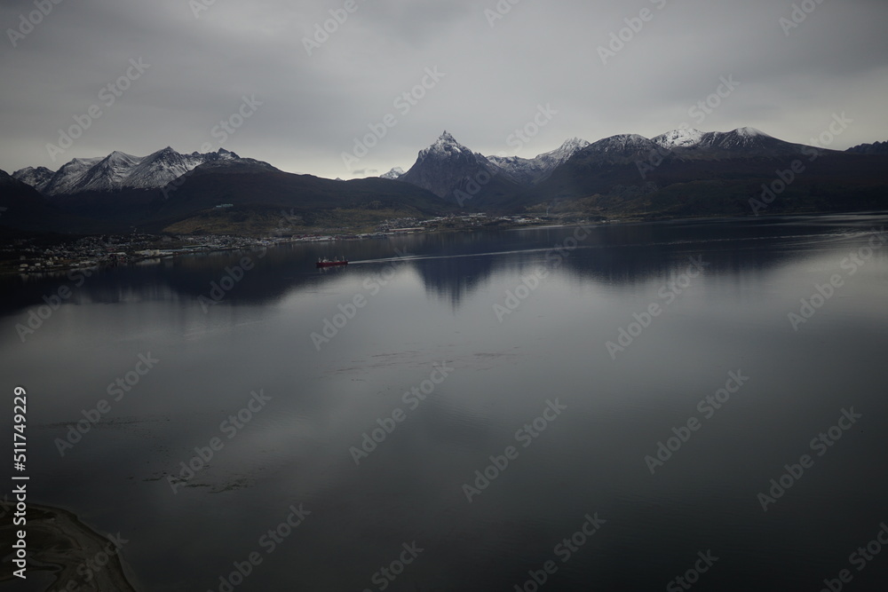 the photo captures the moment of takeoff and flight by plane over Ushuaia — a city and port in southern Argentina.