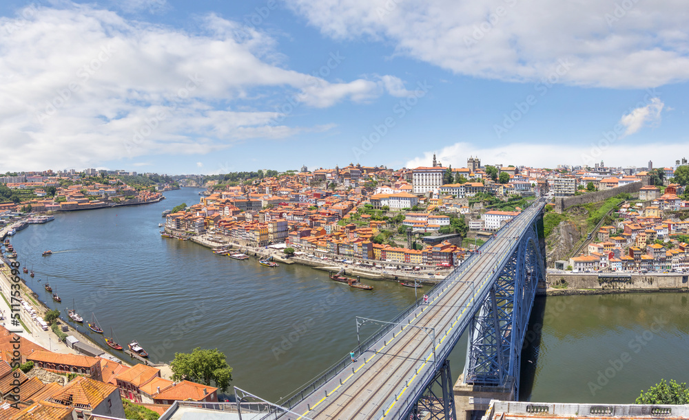 Embankment Ribeira in old town, the Dom Luis I Bridge and Douro river, cityscape. Porto, Portugal