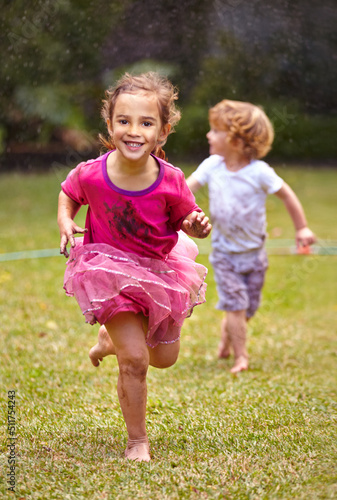 Running as fast as can be. Shot of a little girl running with her little brother outside.