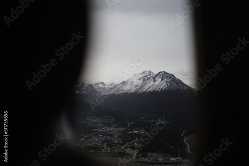 the photo captures the moment of takeoff and flight by plane over Ushuaia — a city and port in southern Argentina.