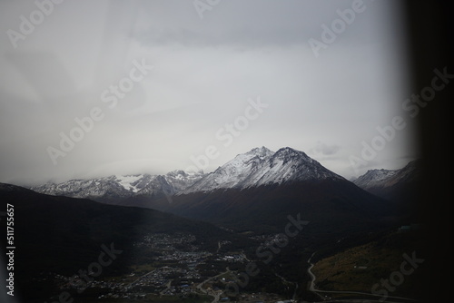 the photo captures the moment of takeoff and flight by plane over Ushuaia — a city and port in southern Argentina.