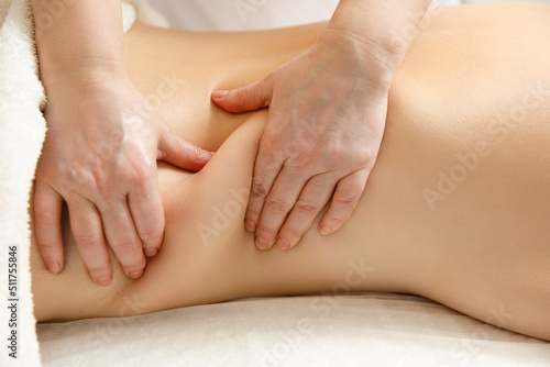 The masseur gives the woman an anti-cellulite abdominal massage.