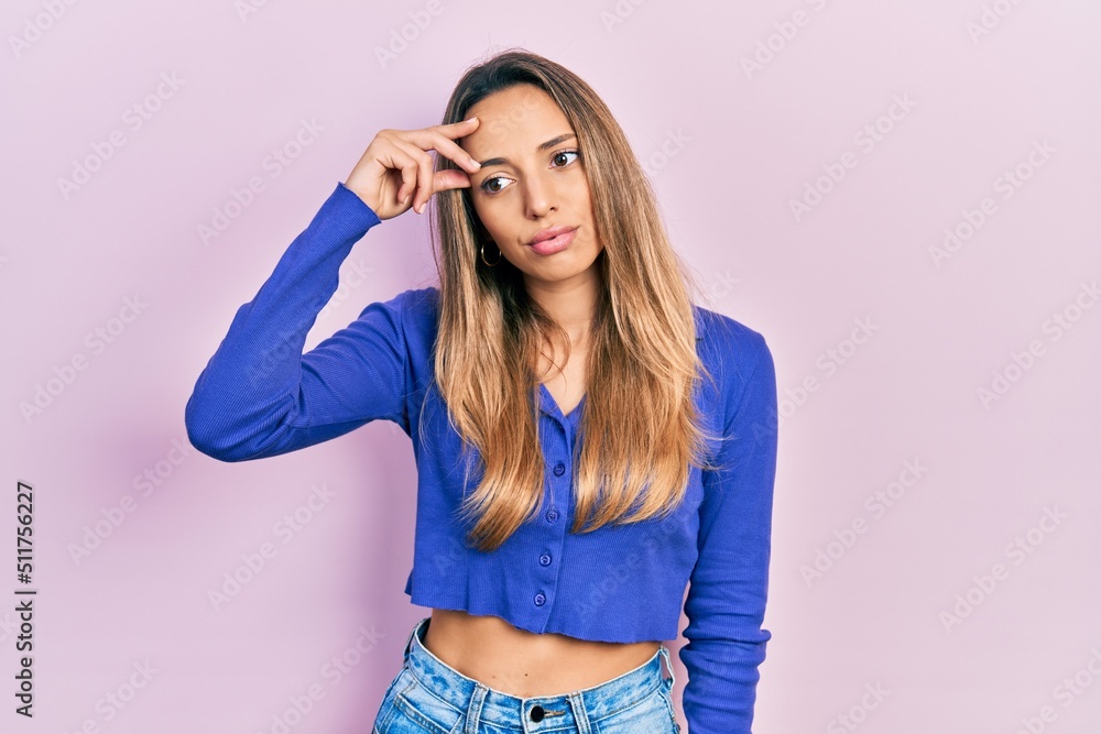 Beautiful hispanic woman wearing casual blue shirt worried and stressed about a problem with hand on forehead, nervous and anxious for crisis Beautiful hispanic woman wearing casual blue shirt worried and stressed about a problem with hand on forehead, nervous and anxious for crisis
