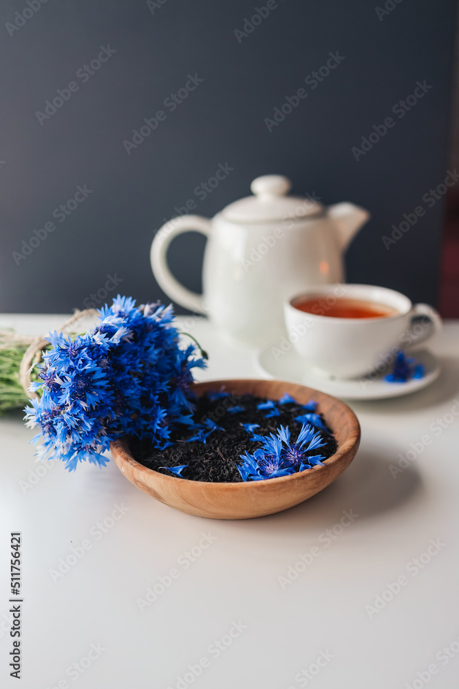 Black natural tea with cornflower petals on the table Black natural tea with cornflower petals on the table