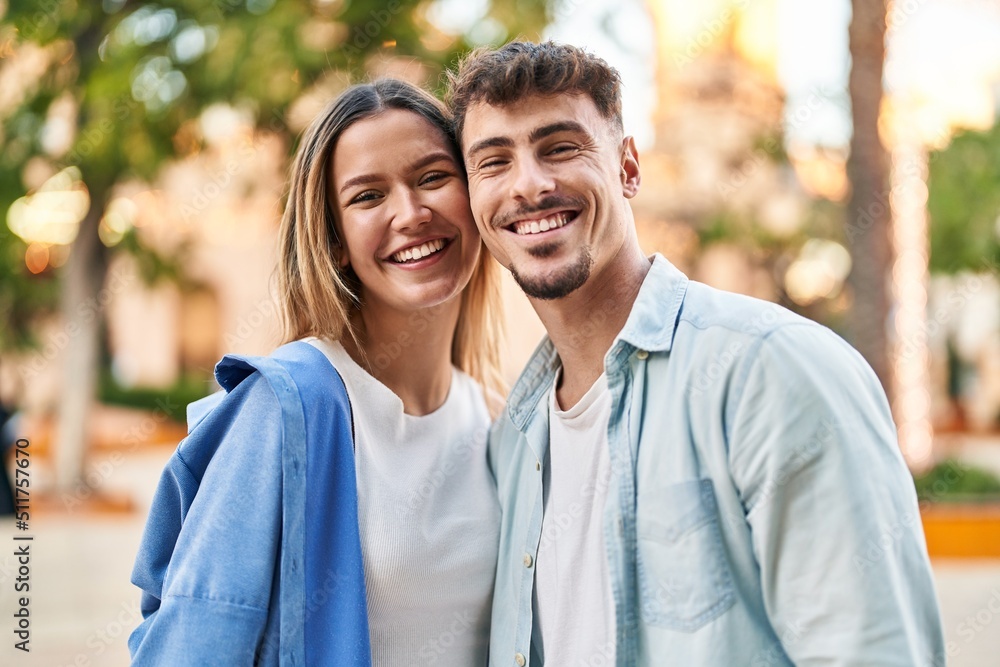 Young man and woman couple smiling confident standing together at street