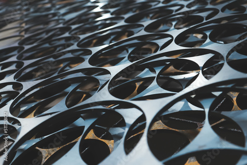 Steel sheets with the same pattern cut out on a black background