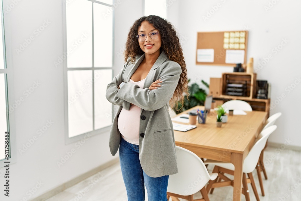 Young latin woman pregnant smiling confident standing with arms crossed gesture at office Young latin woman pregnant smiling confident standing with arms crossed gesture at office