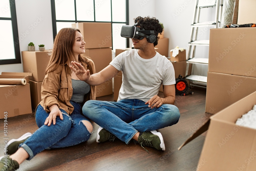 Young couple smiling happy playing with 3d vr glasses at new home. Young couple smiling happy playing with 3d vr glasses at new home.