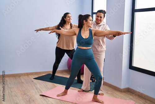 Three woman wearing sportswear training yoga at sport center