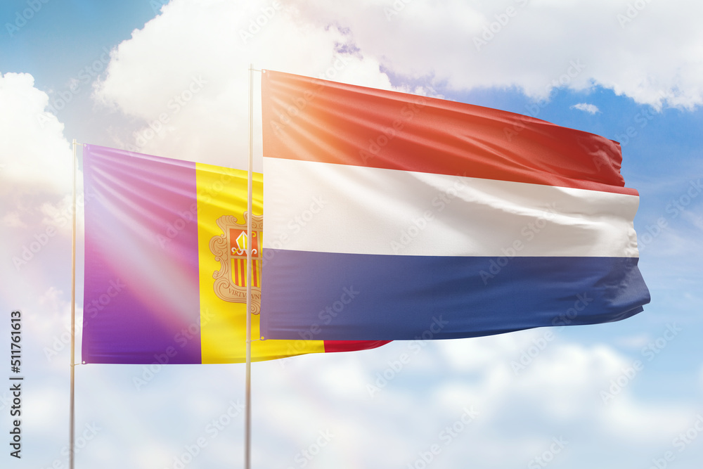 Sunny blue sky and flags of netherlands and andorra Sunny blue sky and flags of netherlands and andorra
