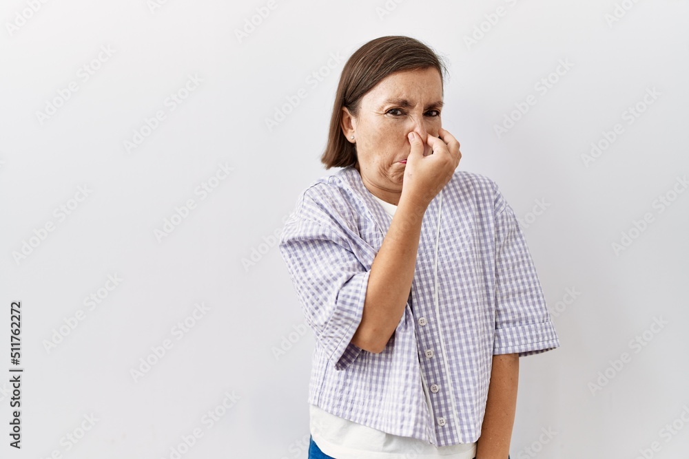 Beautiful middle age hispanic woman standing over isolated background with hand on chin thinking about question, pensive expression. smiling and thoughtful face. doubt concept. Beautiful middle age hispanic woman standing over isolated background with hand on chin thinking about question, pensive expression. smiling and thoughtful face. doubt concept.