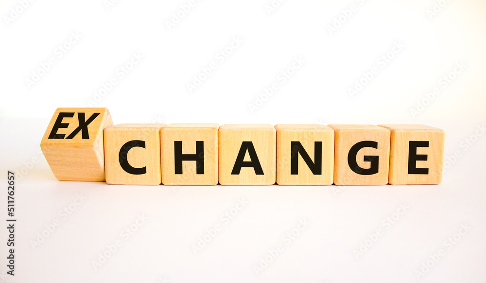 Change or exchange symbol. Turned wooden cubes and changed the concept word Change to Exchange. Beautiful white table white background. Copy space. Business and change or exchange concept. Change or exchange symbol. Turned wooden cubes and changed the concept word Change to Exchange. Beautiful white table white background. Copy space. Business and change or exchange concept.