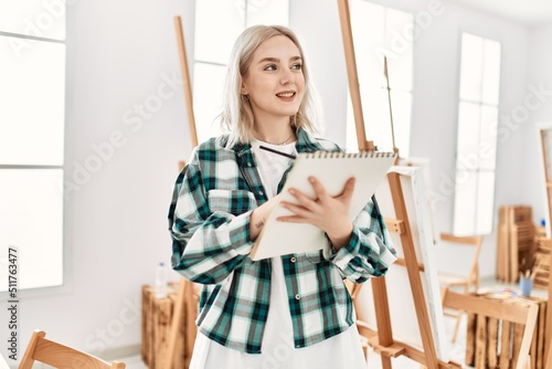 Young artist student girl smiling happy painting at art studio.