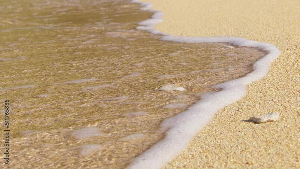 Cinematic small smooth foamy waves shot on RED camera. Slow motion