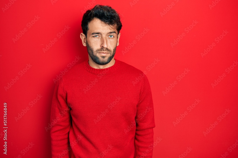 Handsome man with beard wearing casual red sweater skeptic and nervous, frowning upset because of problem. negative person. Handsome man with beard wearing casual red sweater skeptic and nervous, frowning upset because of problem. negative person.