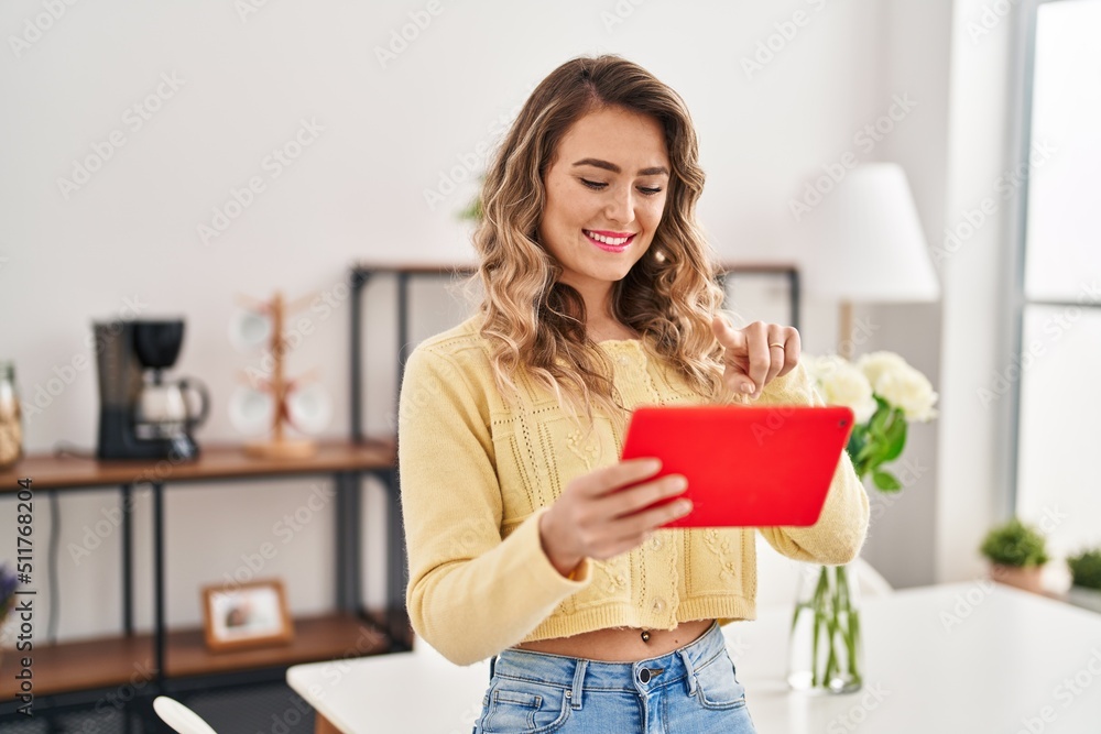 Young woman using touchpad standing at home Young woman using touchpad standing at home