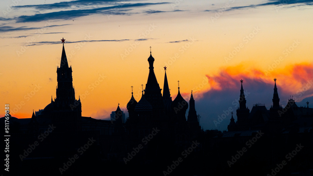Fototapeta premium Black silhouette of Cathedral of Vasily the Blessed, Spasskaya Tower and Kremlin. Sunset sky. High quality photo
