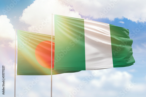 Sunny blue sky and flags of nigeria and bangladesh photo