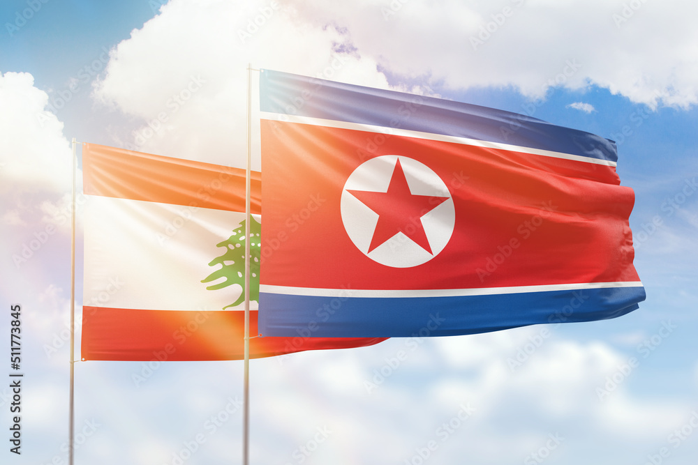 Sunny blue sky and flags of north korea and lebanon